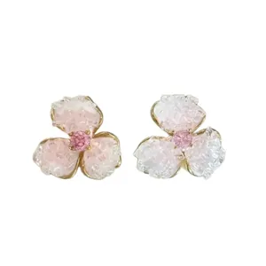 Elegant three-petal flower stud earrings with pink and white crystals in gold settings