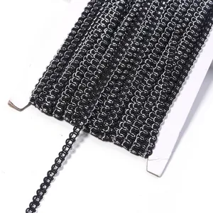 Close-up detail view of black and silver metallic wave trim ribbon, ideal for sewing.