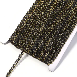 Black and gold metallic wavy braid trim close up, detailed view of S-shaped ribbon edging.