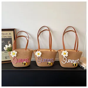 Detailed view of three straw woven summer beach tote bags with colorful embroidery