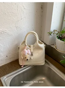 Elegante borsa a secchiello beige da donna, borsa a tracolla in pelle PU con ciondolo.