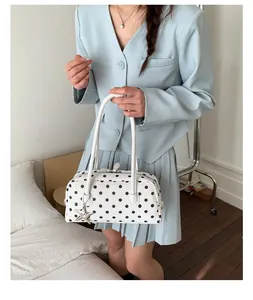 Chic white polka dot bowling shoulder bag detail, stylish PU leather handbag with star charm.