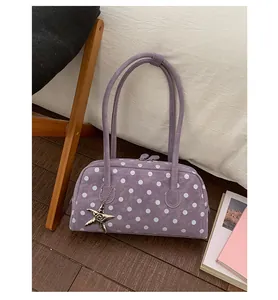 Sweet purple polka dot bowling bag detail, stylish underarm handbag with star charm.