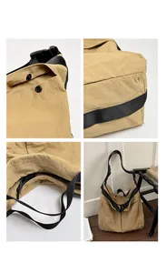 Detailed view of casual khaki canvas shoulder bag showing zipper, straps and snap buttons.