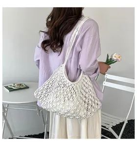 Hand-woven hollow tote bag in off-white, styled with casual summer outfit and tulips
