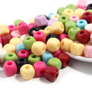 Primer plano de cuentas de cubo acrilico coloridas, ideales para joyeria DIY y artesanias.