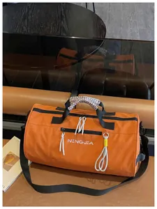 Detailed view of the orange large-capacity waterproof sports gym duffel bag for travel.