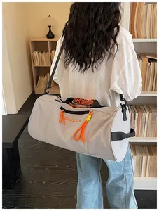 Detail view of the multi-functional waterproof travel duffel bag with orange details.