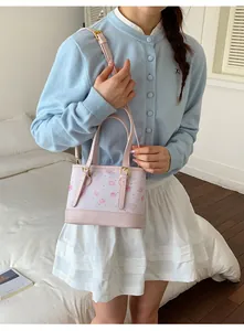 Female model holding a pink printed handbag with cute heart and dessert patterns