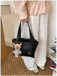 Black leather tote bag for women, large capacity shoulder bag with cute bear pendant and top handle.