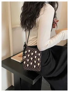 Detailed view of a handmade beaded crochet crossbody phone bag for beach vacations