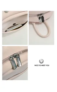 Minimalist pink leather backpack detail view with front pocket and metal zippers.