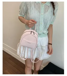 Small pink backpack for women, minimalist casual daypack with pocket and zippers.