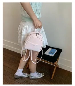 Detailed view of the lightweight pink mini backpack, simple casual design for students.