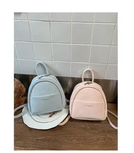 Small mini backpack for women, casual PU leather school bag in light blue and pink.