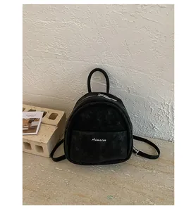 Minimalist black mini backpack detail, casual daily fashion student shoulder bag.