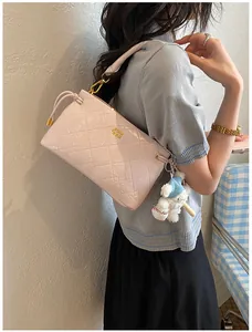 Chic pink quilted underarm shoulder bag for women, stylish commuting handbag with cute charm.