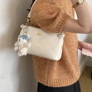 Quilted underarm shoulder bag for women, chic trendy handbag with cute bear pendant.