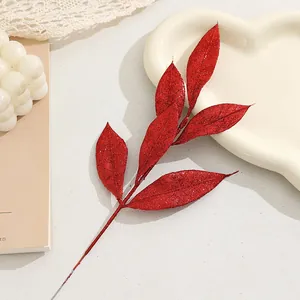 Red glitter artificial leaves branch detail, perfect for Christmas tree decor and DIY wreaths.
