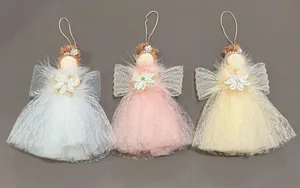 Close-up detail of Christmas angel doll hanging pendants with mesh dresses and feathery wings.