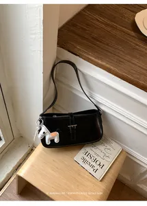 Sac sous les bras noir élégant avec boucle argentée et breloque cheval sur banc