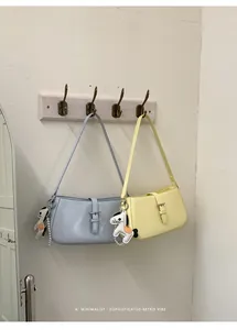Sacs à bandoulière rétro minimalistes en bleu pastel et jaune sur un support bois