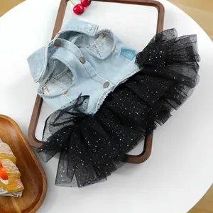 Denim and black tulle pet dress detail, featuring metal buttons and collar tag for small dogs.