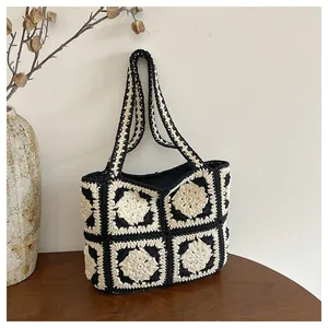 Handgefertigte Häkeltasche mit schwarz-weißem Granny Square Blumenmuster im Retro-Look