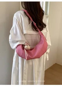 Minimalist pink croissant shoulder bag detail, stylish retro vibe everyday casual crossbody style.