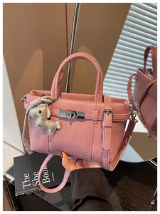Pink textured leather commuter handbag with cute horse charm and shoulder strap