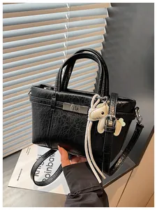 Elegant textured black commuter tote bag featuring puppy charm and adjustable strap