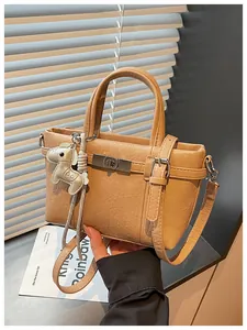 Camel faux leather mini tote bag with horse charm detail for women's daily commute.