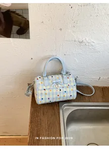 Primer plano de un bolso de mano con lunares azul claro en un mostrador de madera rústica