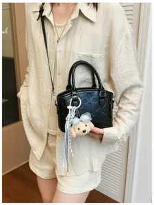 Korean style black crossbody bag with cute plush dog charm, stylish daily shoulder handbag for women.