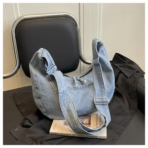 Stylish light blue denim dumpling bag with adjustable wide strap for university