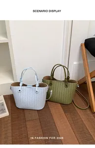 Detail view of stylish woven leather handbag for women, featuring top handles and shoulder strap.