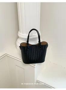 Detailed view of the elegant black woven tote bag showcasing premium texture and design.