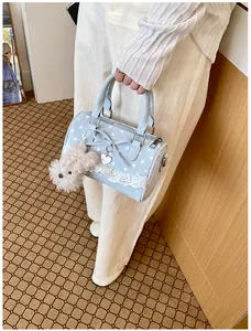 Sweet polka dot handbag detail, light blue bow lace pillow bag with cute plush charm.
