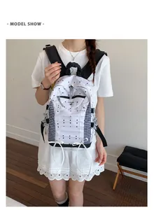 Detailed view of lightweight white polka dot backpack with navy checkered side panels