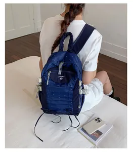 Detailed back view of a lightweight navy blue polka dot backpack for school and travel