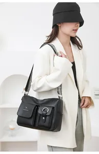 Black soft leather shoulder bag for women, large capacity crossbody bag with wide strap.