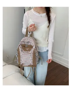 Lightweight brown checkered backpack for students, perfect for travel and daily commute.
