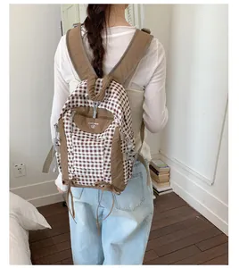 Stylish brown and white checkered school backpack shown from the back view detail