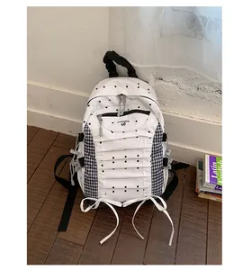 Stylish white polka dot backpack with blue checkered side panels and cute ribbon bow accents