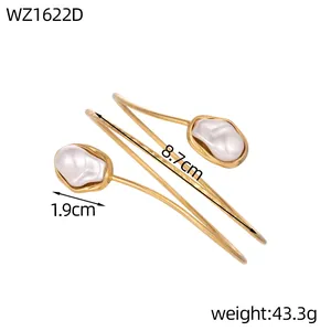 Detail view of golden geometric arm cuff with pearls showing 8.7cm length and weight