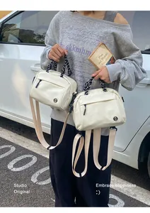 Modern multifunctional lightweight small backpack and crossbody bag shown in street setting