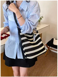 Black and white striped woven tote bag large capacity casual shoulder bag for women commuting.