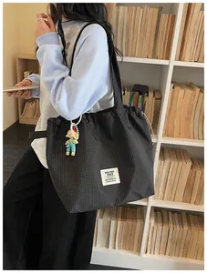 Large black grid canvas tote bag with drawstring closure for casual daily commuting