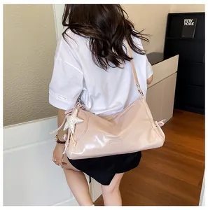 Stylish glossy pink shoulder bag for women, large capacity commuter messenger bag with star pendant.