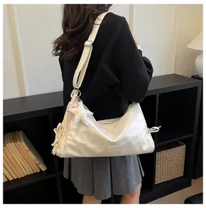 Detailed view of the women's retro style white tote shoulder bag with cute star pendant.